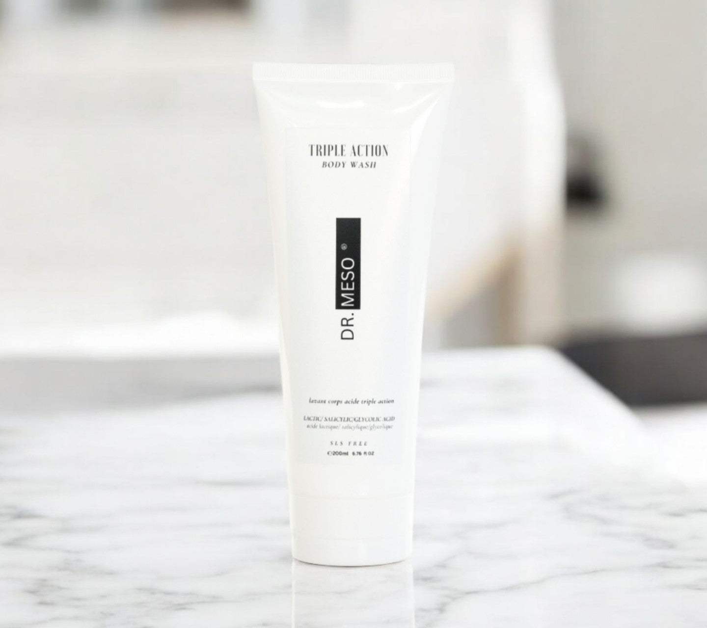 Dr. Meso triple action body wash bottle on a marble surface