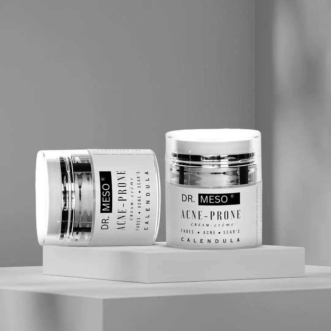 Multiple jars of cream formulated for acne-prone skin.